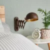 Aplique de pared Curtis de Lindby, color óxido, ajustable, 57 cm, E14