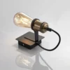 Aplique de pared Lindby Aurella, altura 16 cm, latón envejecido, metal