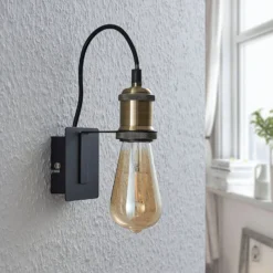 Aplique de pared Lindby Aurella, altura 16 cm, latón envejecido, metal