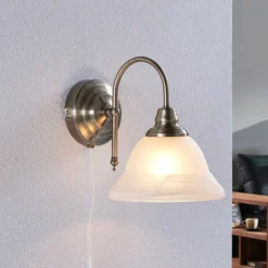 Aplique de pared Lindby Hanna, 18 m, latón envejecido, metal, cristal