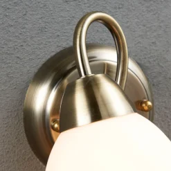 Aplique de pared Lindby Mael, altura 20 cm, latón envejecido, interruptor