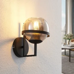 Aplique de pared Lindby Marinka, altura 20 cm, negro, cristal ahumado