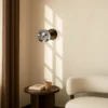 Aplique de pared Lindby Valentina, gris/negro, cristal, Ø 10 cm