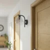 Aplique de pared Pendura de Lindby, Ø 15 cm, negro, cristal