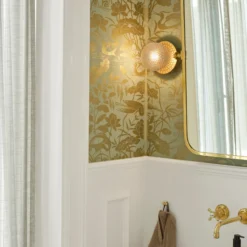 Aplique Nuura Liila 1, IP44, Ø 14 cm, dorado/transparente