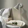 Dyberg Larsen Aplique de pared Sleep, blanco masilla, Ø 15 cm, acero
