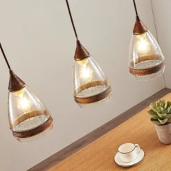 Lámpara colgante de cristal Lindby Millina, 70 cm, marrón óxido, 3 luces.