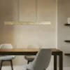 Lámpara colgante LED Lucande Nivara, 117 cm, dorada, metal