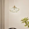Lámpara colgante Lindby Piatra, ámbar/latón, cristal, Ø 16 cm, G9
