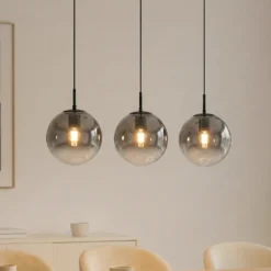 Lámpara colgante Lucande Veloura, 3 luces, 84 cm, cristal, madera