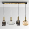 Lámpara colgante Norma, 98 cm, 4 luces, negro/latón, cristal