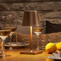 Lámpara de mesa LED recargable Nuindie mini, USB-C, bronce, IP54, atenuable.