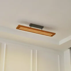 Lámpara de techo Lindby LED Nesaja, negra, madera, 98cm, atenuable